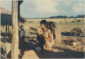 Photograph album, Yaruro fieldwork, p. 26, photo 1, girl eating