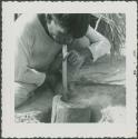 Photograph album, Yaruro fieldwork, p. 30, photo 2, man blowing through pipe