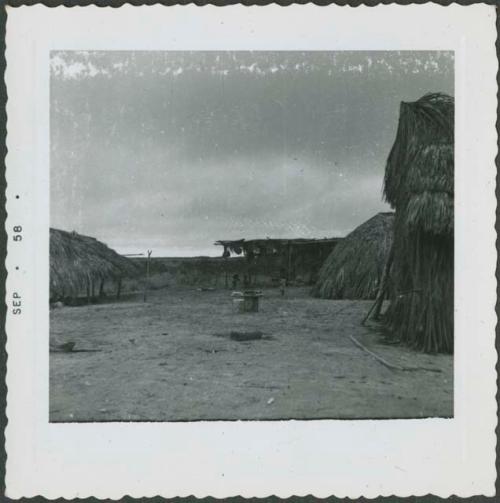 Photograph album, Yaruro fieldwork, p. 33, photo 3, yard with wooden structures with thatched roof