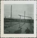 Photograph album, Yaruro fieldwork, p. 34, photo 4, constructing a building, vertical and horizontal poles