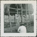 Photograph album, Yaruro fieldwork, p. 38, photo 2, constructing a building, setting side poles