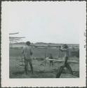 Photograph album, Yaruro fieldwork, p. 38, photo 4, constructing a building, working on the poles
