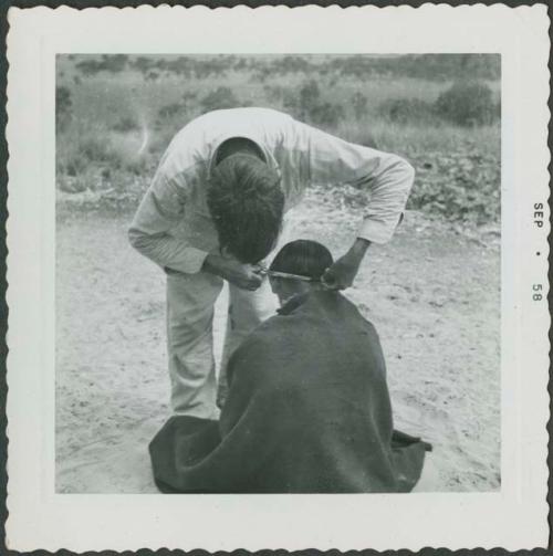 Photograph album, Yaruro fieldwork, p. 39, photo 4, boy getting his hair cut