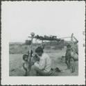 Photograph album, Yaruro fieldwork, p. 42, photo 2, man holding cup with children around