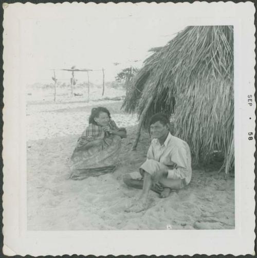 Photograph album, Yaruro fieldwork, p. 45, photo 1, two people sitting outdoors on the ground