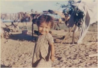 Photograph album, Yaruro fieldwork, p. 53, photo 1, toddler smiling at camera