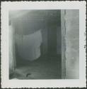 Photograph album, Yaruro fieldwork, p. 65, photo 4, view inside building with sheet drying