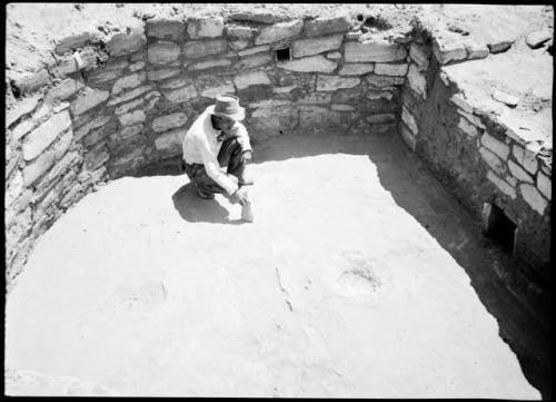 Site 107, Kiva A, showing firepit, ventilator, and one of the niches, looking east.