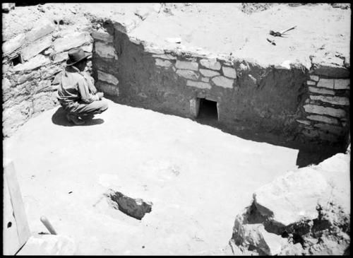 Site 107, Kiva A, showing firepit, ventilator shaft and ashpit, looking east.