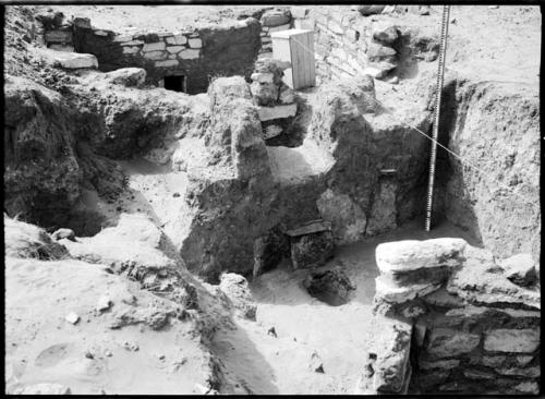 Site 107, Room 11, showing firepit and end of ventilator shaft, slabs covering the entrance.