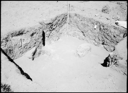 Site 107, Room 12, showing firepit, post holes and adobe wall (?), looking west.