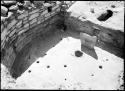 Site 108, Room 2, D-shaped kiva, showing firepit, deflector, ventilator shaft, masonry wall, niche and holes in adobe floor.