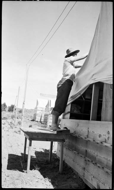 Penny Davis fixing up the pottery tent.