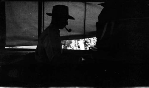 Watson Smith playing the piano.  (silhouette)