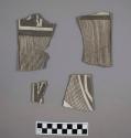 Rim and body sherds from a bowl with linear and geometric black on white designs