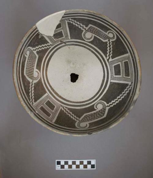 Ceramic bowl, brown on white geometric interior, plain fire-clouded exterior