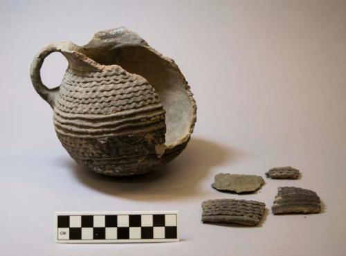 Ceramic partial pitcher and sherds, corrugated and banded exterior