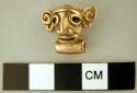 Gold bell-like object in form of human head