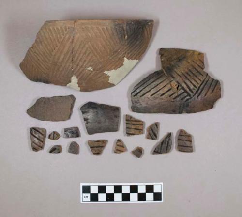 Ceramic rim and body sherds, engraved, mended and reconstructed, redware