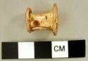 Gold nose or lip clip, probably a trophy piece.  Undecorated cylinder