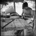 Economic life/Arts and crafts: man working at construction table, possibly making a belt