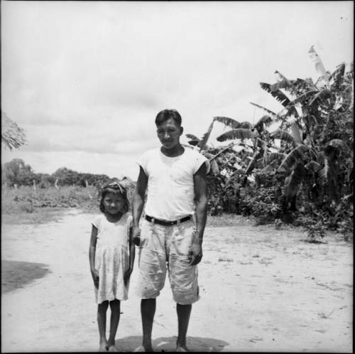 People: man and young girl posing for photograph