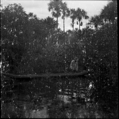 Work and food prep: man in canoe on the river