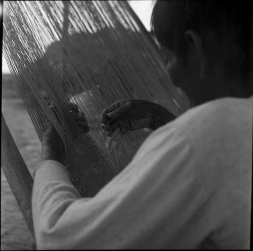 Work and techniques: close view of woman weaving