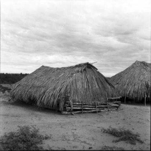 Houses and house buildings: wooden structure with thatched roof