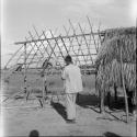 Houses and house buildings: putting thatch on roof