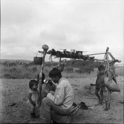 Activities and rest: man holding cup with children around