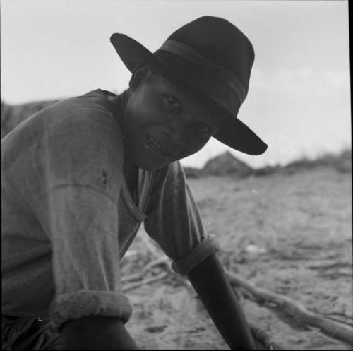 Portraits of people: young man wearing hat leaning over