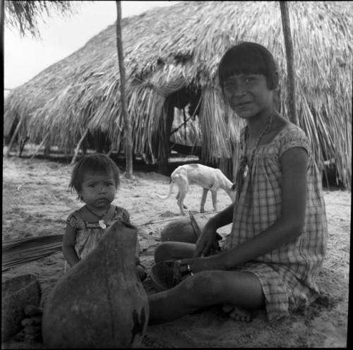 Portraits of people: young woman and child sitting on the ground