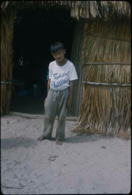 Young boy in white shirt and no shoes