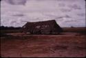 Thatched building under cloudy skies