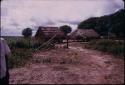 Thatched buildings under cloudy skies