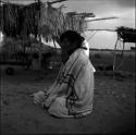 Portraits of people: man sitting wrapped on the ground with blanket