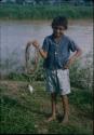 Boy in blue shirt holding rope