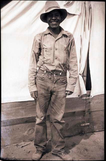 Leland Dennis standing in front of a tent