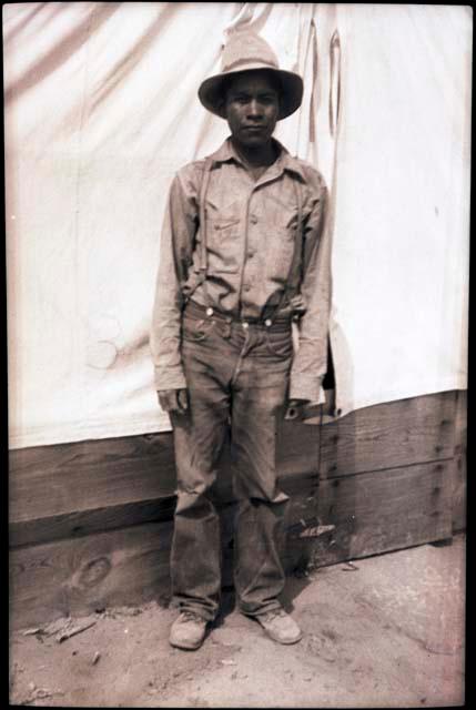 Leland Dennis standing in front of a tent