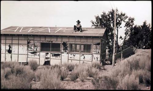 Jay Hooton painting AWATOVI on cookshack roof