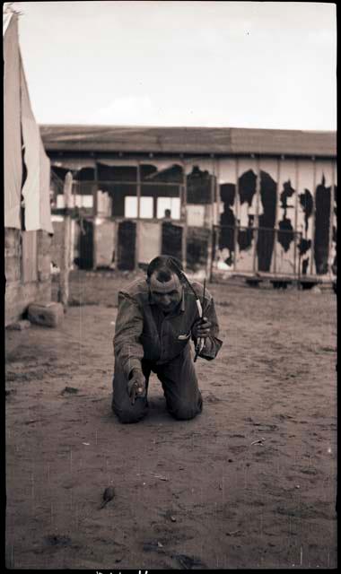 Al shooting at a rubber mouse. This may have been his birthday. He is holding a bow and arrows.