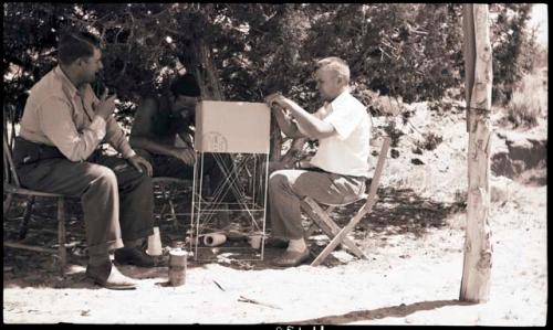 Jo Brew, Peter Blos and laden Stevens, Alden working on a kite he hopes to take pictures from