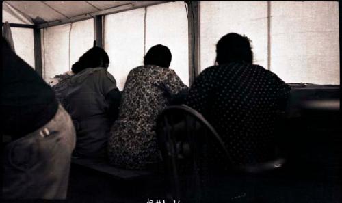 Hopi women drawing designs in the pottery tent