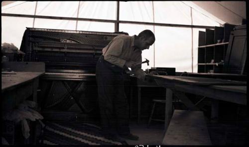 Carlos repairing the front cover of the piano