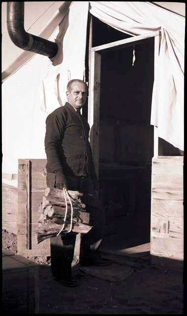 Carlos with wood for his tent stove