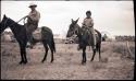 Carlos riding a horse, and a Hopi boy riding a mule