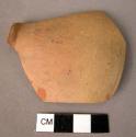 Fragment of thin hard pottery bowl profile - ring footed, buff slipped, unburnis