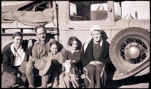 Anne Morris, Earl, Boo (Sarah), Bib (Elizabeth) and nursemaid on the running-board of their truck