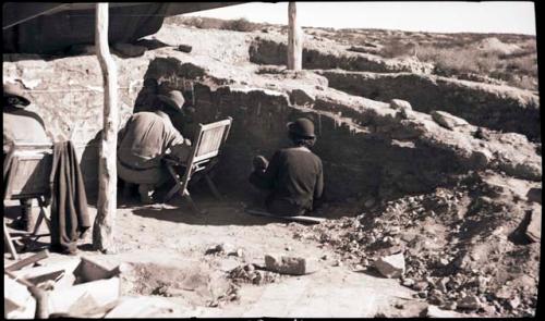 Mr. Scott, Watson and Dorothy Newton at work in kiva, backs only